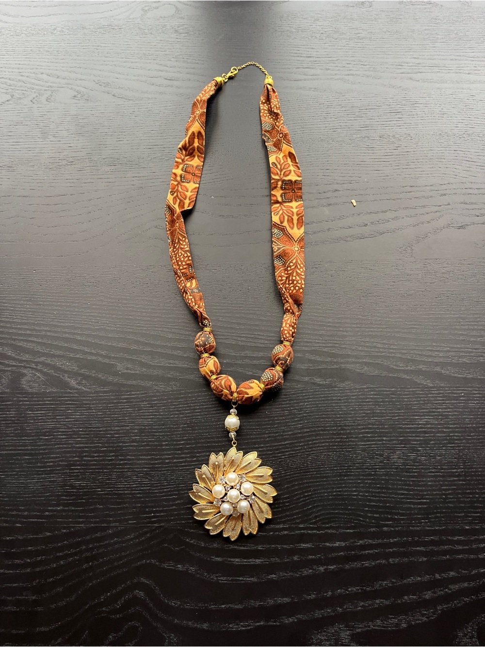 Gold Floral Pendant Necklace with Orange Fabric Beaded Strand